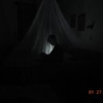 Reading at night under the mosquito net